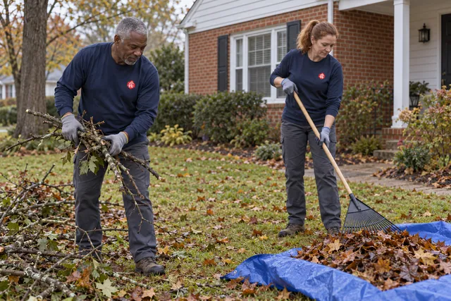 Team clearing seasonal yard debris around a home